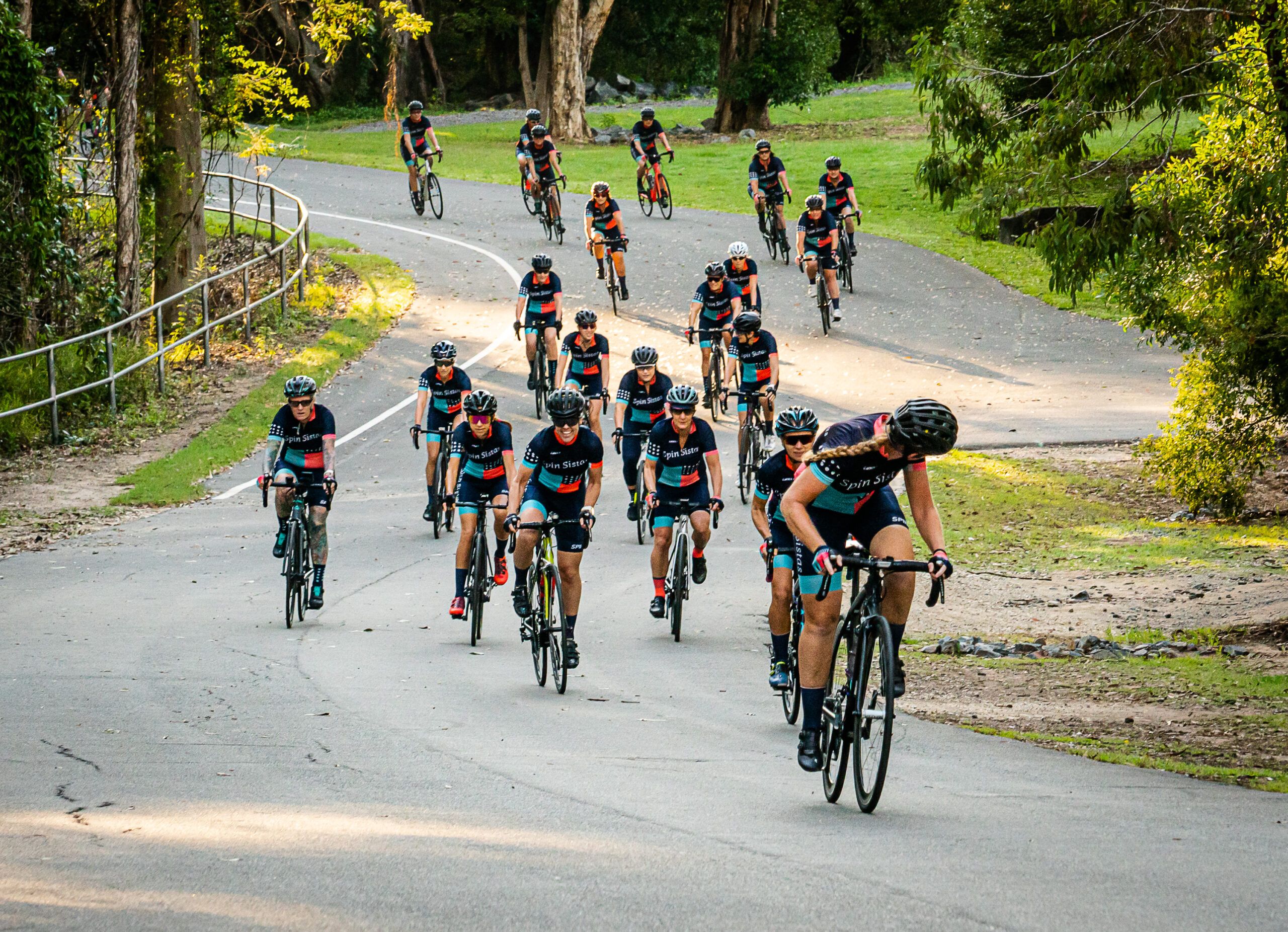 A large Spin Sistas bunch climbing a winding road