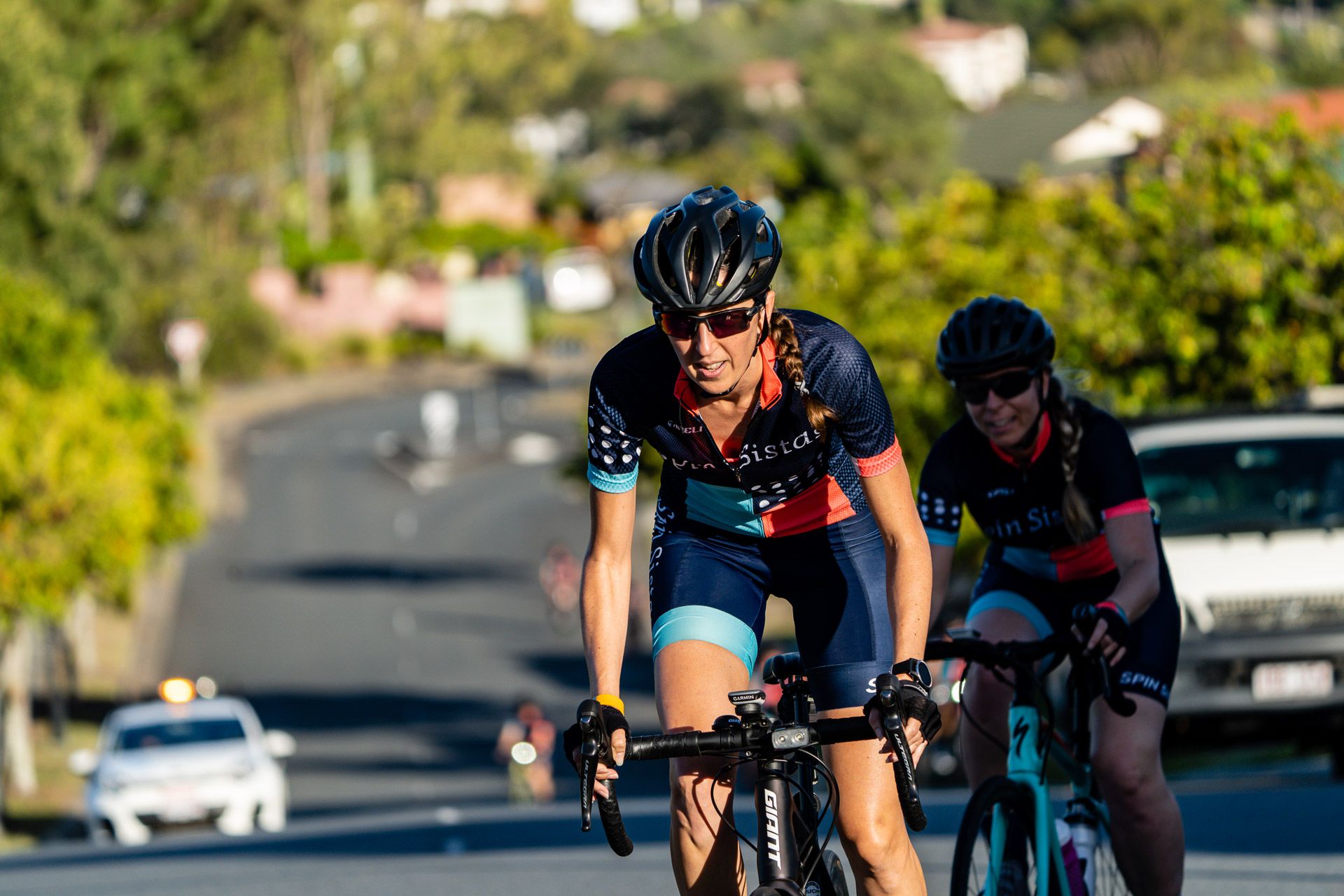 A Spin Sistas rider leading a group on the road